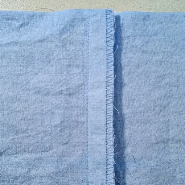Detail kampuh tutup pada pakaian dengan hasil finishing yang rapi Detail kampuh tutup pada pakaian dengan hasil finishing yang rapi