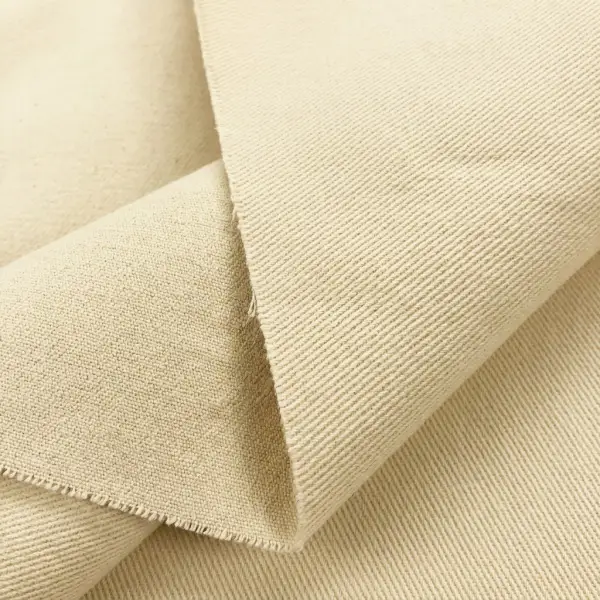 Close-up tekstur kain kanvas twill dengan pola diagonal yang terlihat jelas