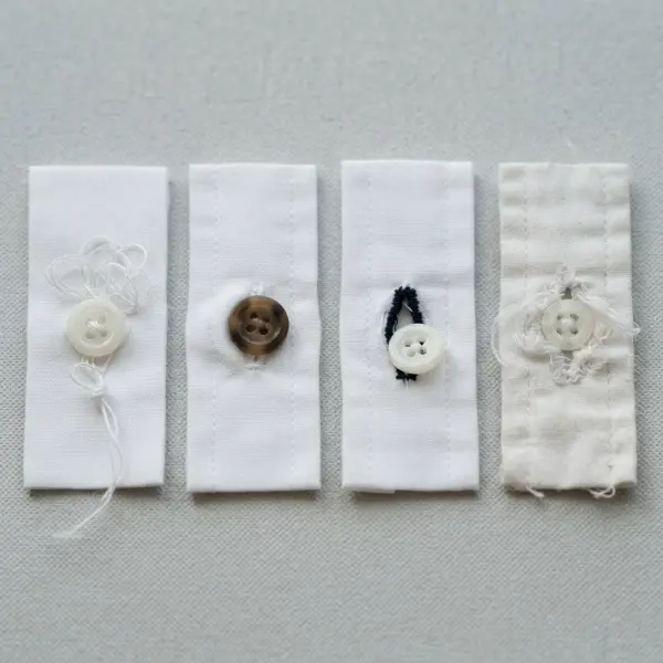 Loose button, incorrect buttonhole size, frayed buttonhole, and misaligned button placement