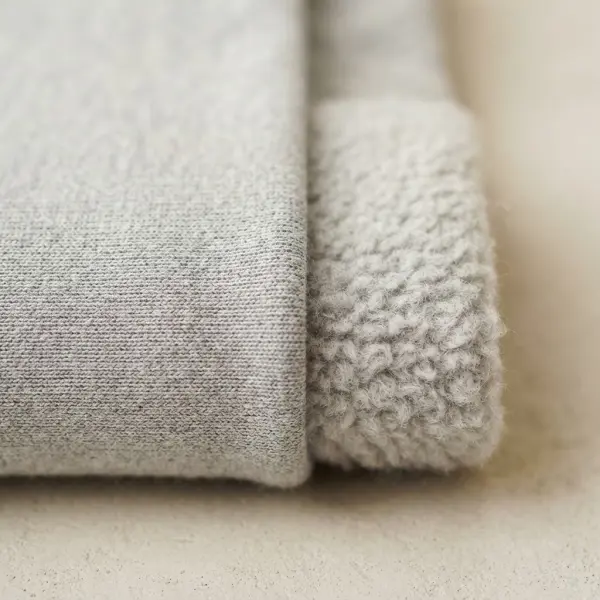 Brushed sweatshirt fleece with smooth face and soft napped interior