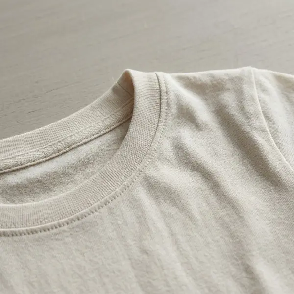 Close-up of soft children's jersey clothing showing fabric texture, neckline construction, and smooth stitching details