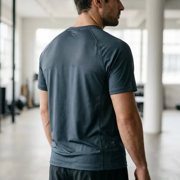 Athletic training shirt featuring a fine knitted mesh ventilation panel across the upper back