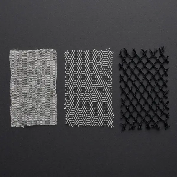 Close-up textile samples showing fine tulle, regular bobbinet net, and coarse fishnet structures