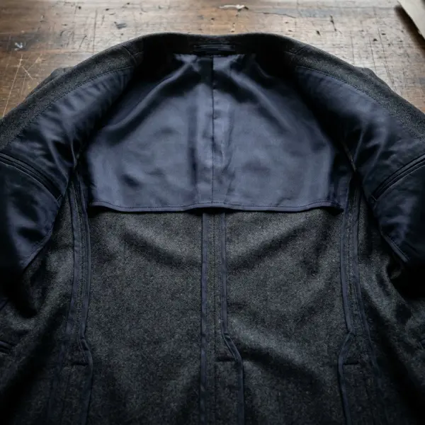 Close-up of partially lined wool blazer showing neatly bound exposed interior seams and upper-back lining