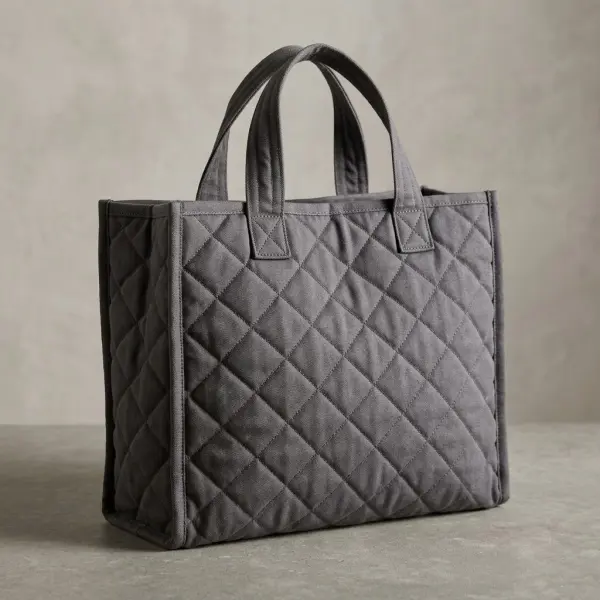 Quilted fabric tote bag showing precise stitched panels, soft padding, and reinforced handles