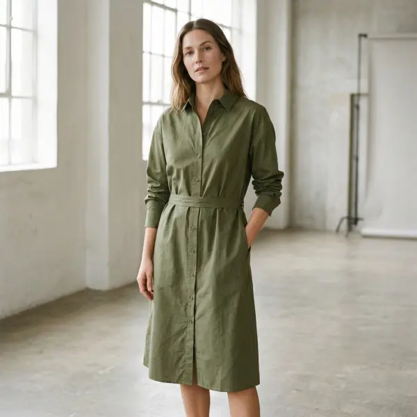 Cotton shirt dress with a full-length front button placket, structured collar, and coordinated waist shaping