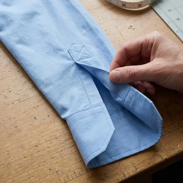 Close-up of a tower sleeve placket showing the reinforced upper opening and clean stitching before cuff attachment